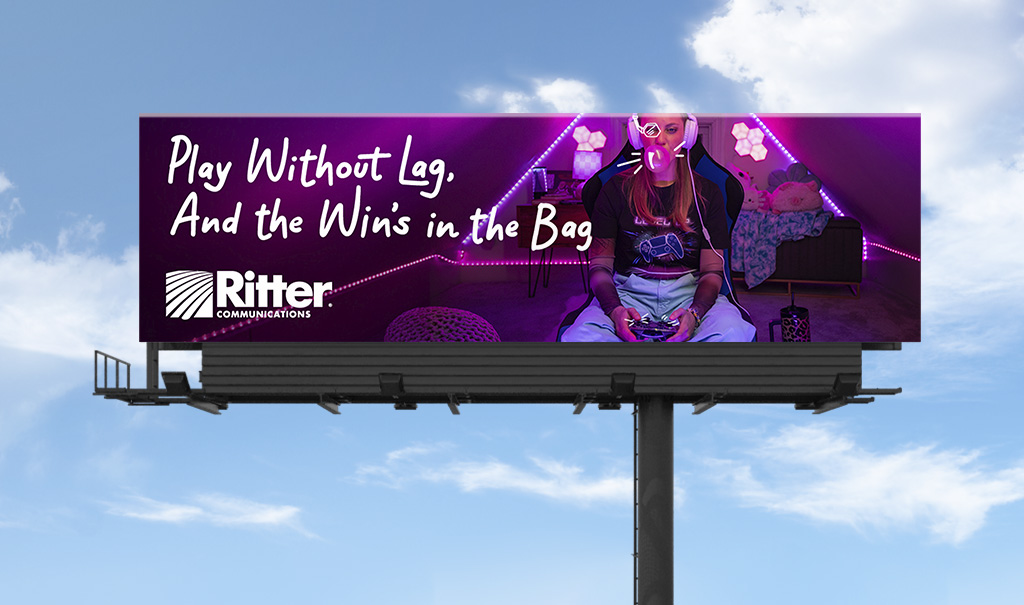 A purple billboard featuring a young girl playing a video game with the headline “Play without lag, and the win's in the bag”