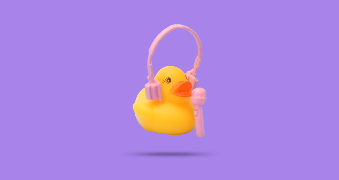 A rubber duckie wearing headphones and talking into a microphone.