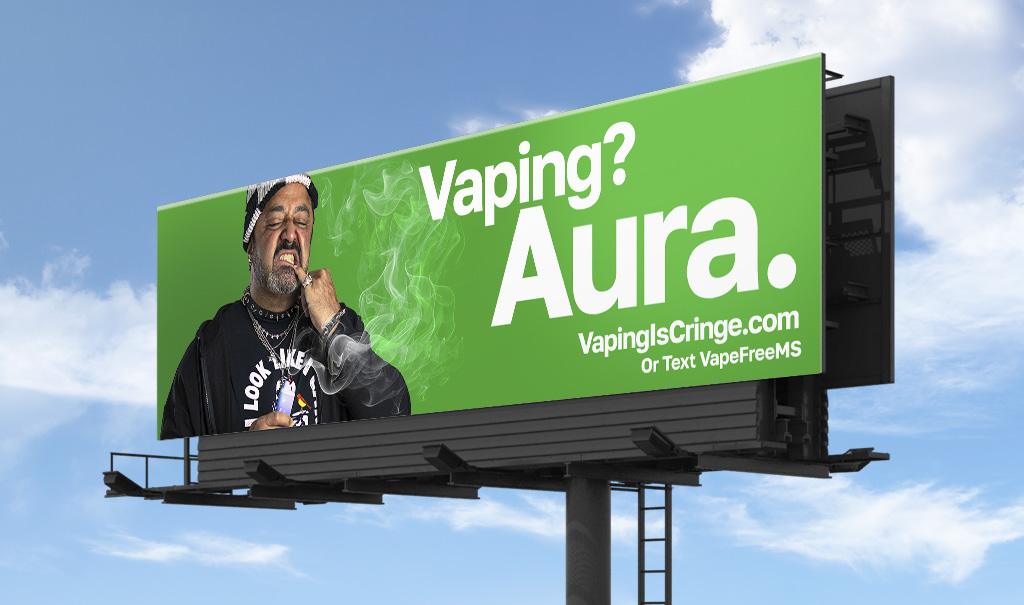 A green billboard featuring an image of a man vaping with the headline, “Vaping? Aura.”