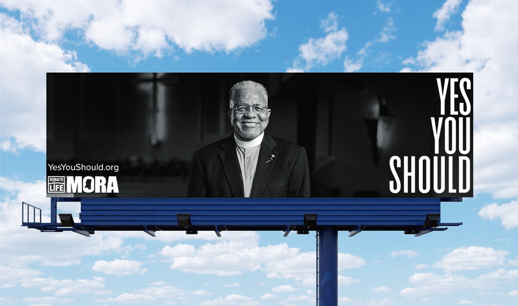 A billboard featuring a black and white image of a pastor with the headline, “Yes You Should”