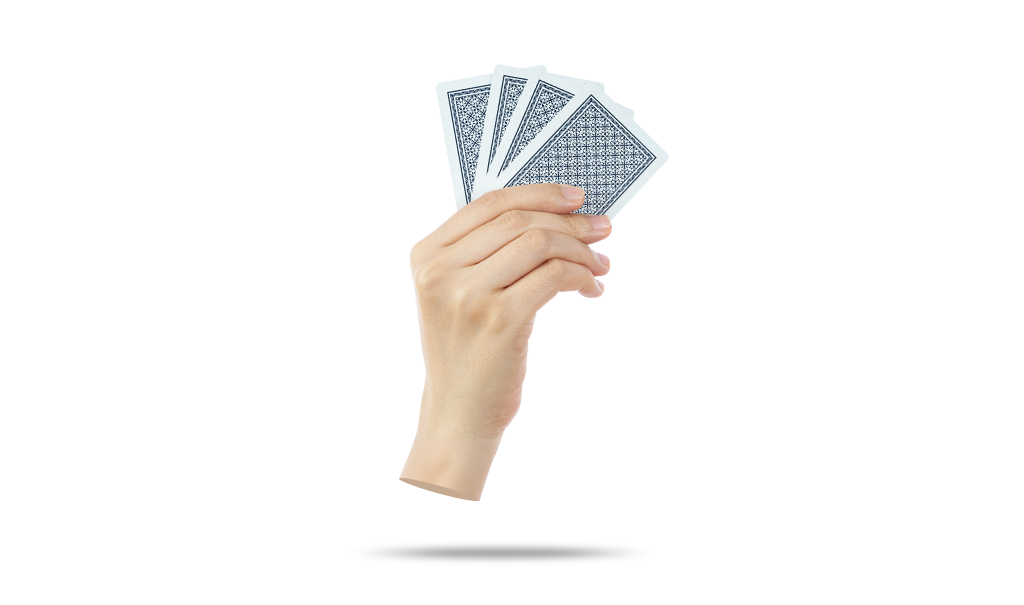 A hand holding some playing cards in front of a white background.